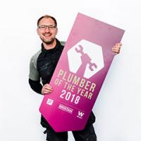 Steve Bartin holding Plumber Of The Year sign